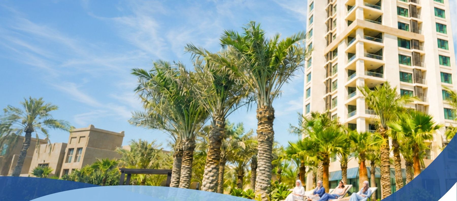 Lagoona Beach Luxury Resort tower rising above palm-lined gardens and pools.